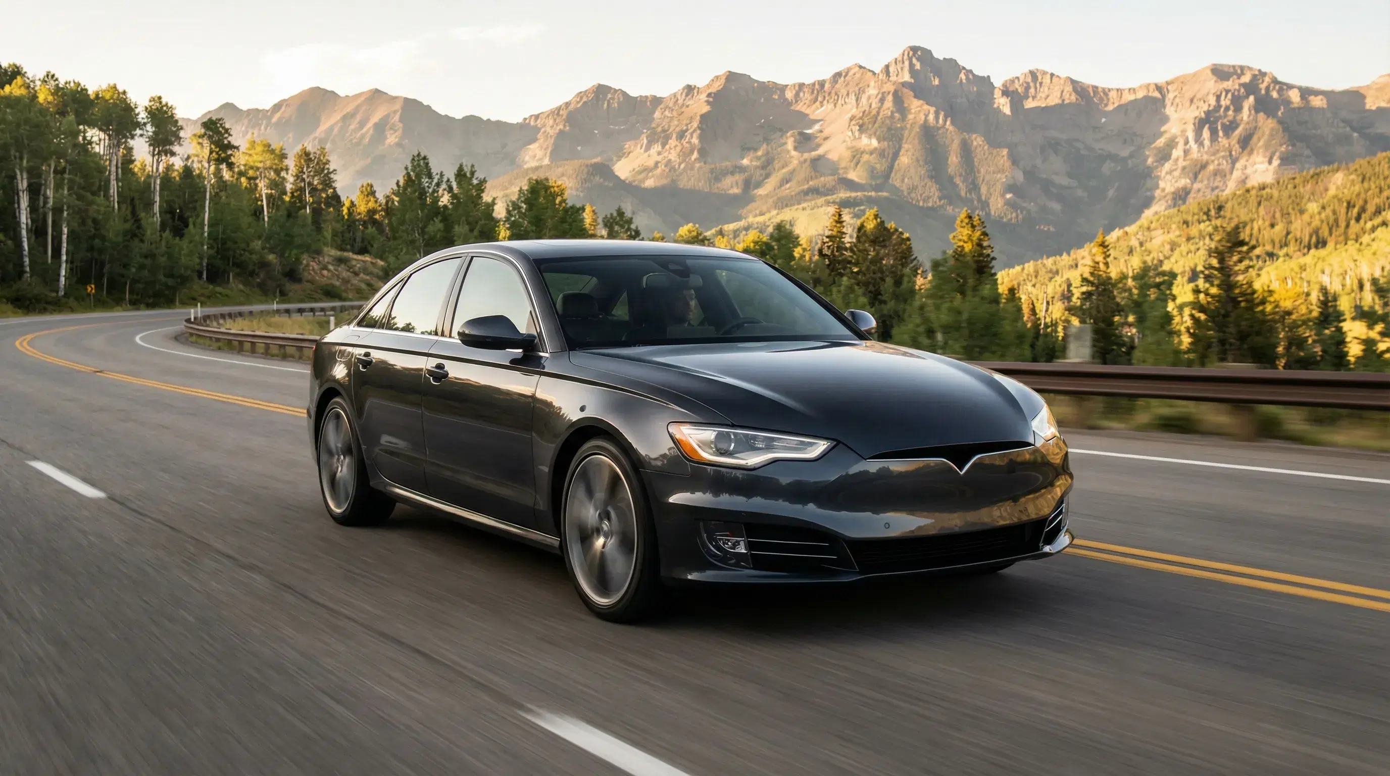 Premium sedan driving on Colorado highway with Rocky Mountains